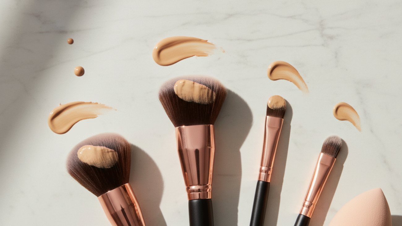 A stylish flat lay of top foundation brushes with makeup, perfect for beauty tips and reviews.